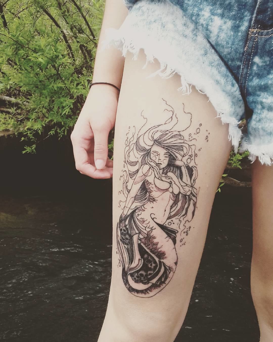 tatuagem feminina de sereia na coxa