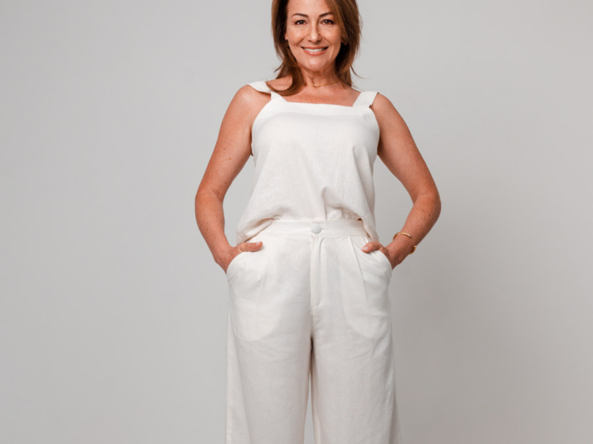 Calça pantalona acima dos 50 anos. Foto mulher com regata branca e calça pantalona branca de alfaiataria 