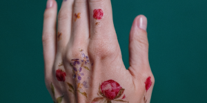 Ideias de tatuagens nas mãos. Foto mão com tatuagem de rosas.
